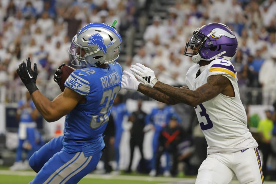 Detroit Lions safety Brian Branch (32) intercepts a pass intended for Minnesota Vikings wide receiver Jordan Addison (3) during the first half of an NFL football game, Sunday, Dec. 24, 2023, in Minneapolis. (AP Photo/Bruce Kluckhohn)