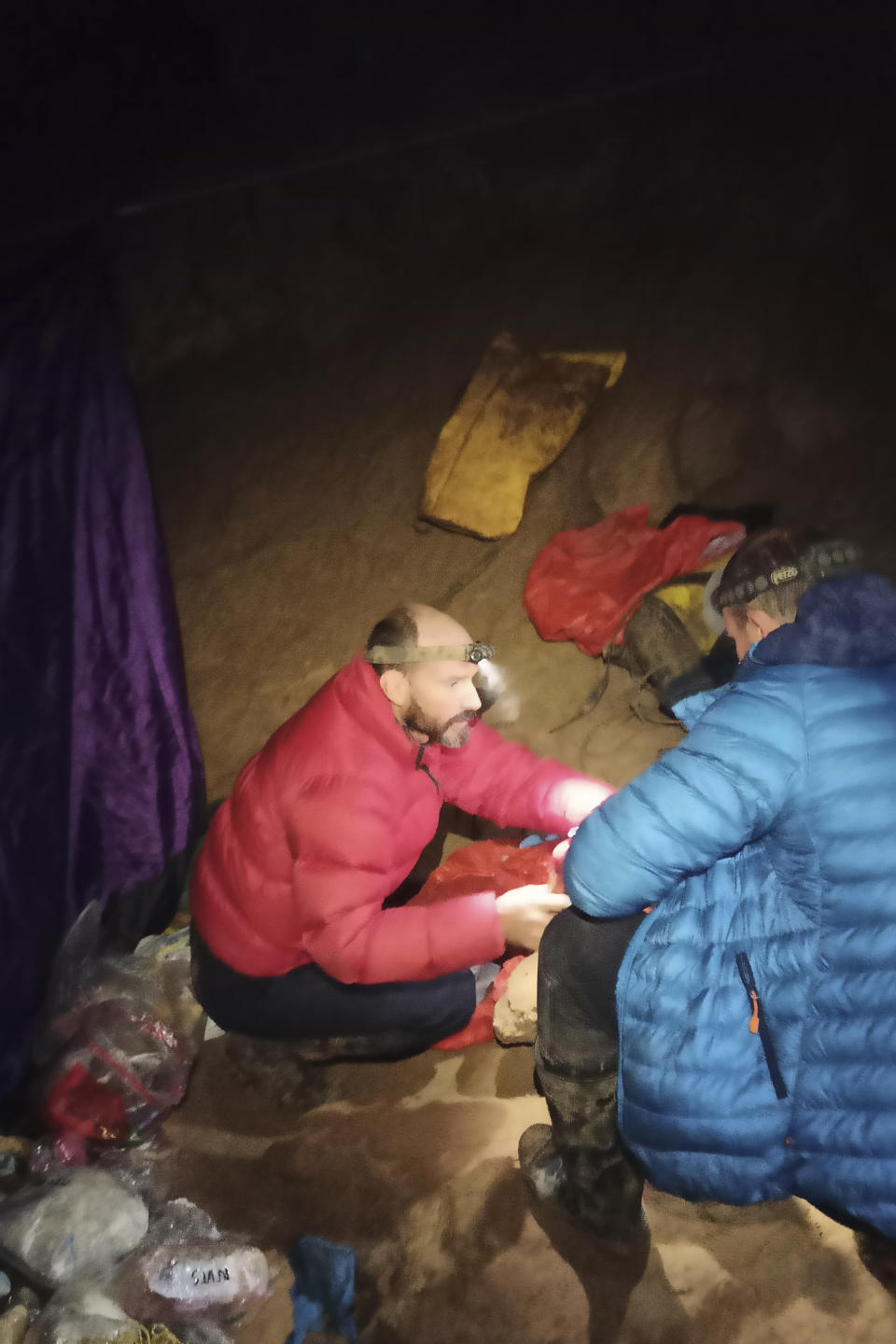 American caver Mark Dickey, left, 40, talks to a colleague inside the Morca cave near Anamur, southern Turkey, Thursday, Sept. 7, 2023. Turkish and international cave rescue experts are working to save an American speleologist trapped at a depth of more than 1,000 meters (3,280 feet) in a cave in southern Turkey after he became ill. (Turkish Government Directorate of Communications via AP)