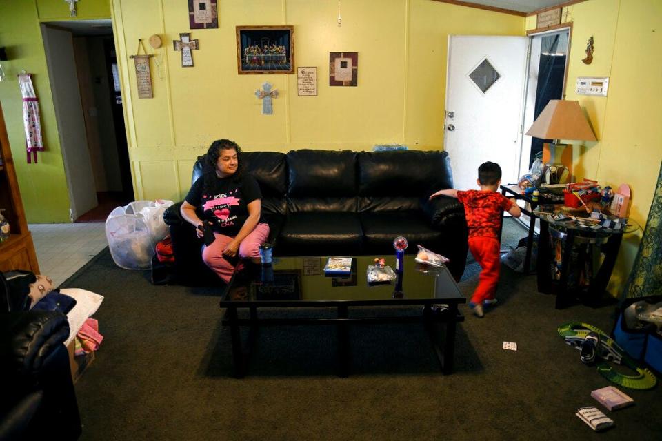 Martina Gonzales and her grandson, Lukas Lee Mora, 4, in their home in Las Vegas, N.M., on Tuesday, May, 3, 2022. Flames raced across more of New Mexico's pine-covered mountainsides Tuesday, charring more than 217 square miles over the last several weeks. Gonzales and her husband have packed up their valuables and are ready to leave the area if the fire tops the ridge behind their house.