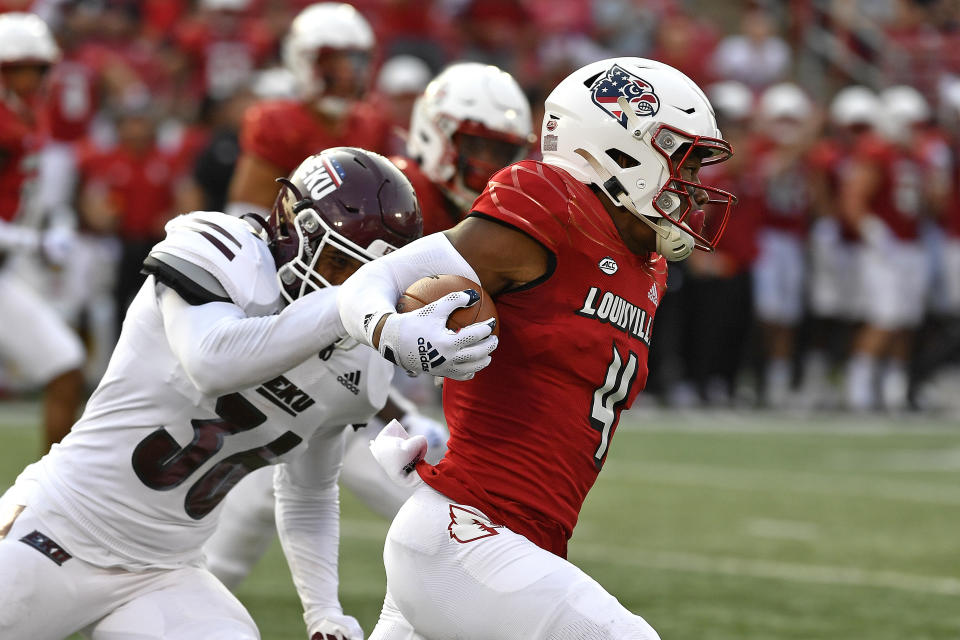 Louisville's Braden Smith (4) evades the grasp of y Eastern Kentucky's Kyle Bailey (36) during the first half of an NCAA college football game in Louisville, Ky., Saturday, Sept. 11, 2021. (AP Photo/Timothy D. Easley)