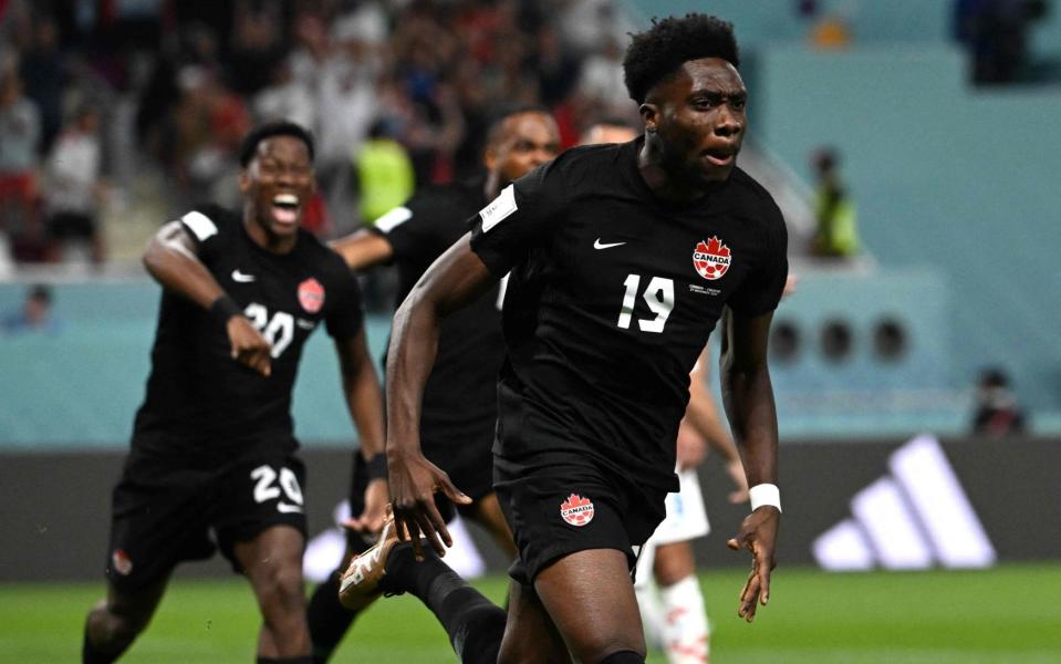 Alphonso Davies celebrates scoring his team's first goal during the Qatar 2022 World Cup Group F football match between Croatia and Canada - Ozon Kose/Getty Images