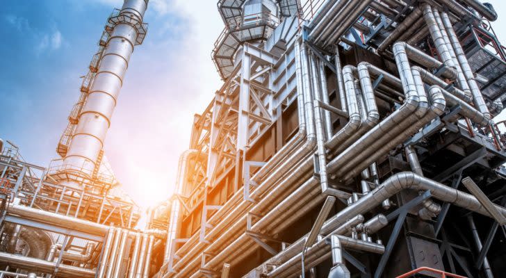 Factory pipes and towers at sunset