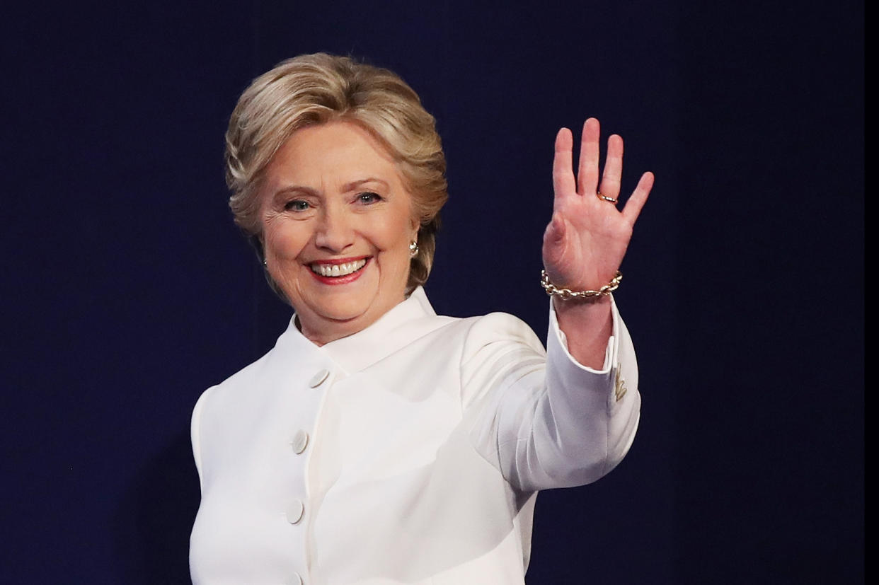 Hillary Clinton waves to the crowd from the stage during a debate. (Drew Angerer / Getty Images)