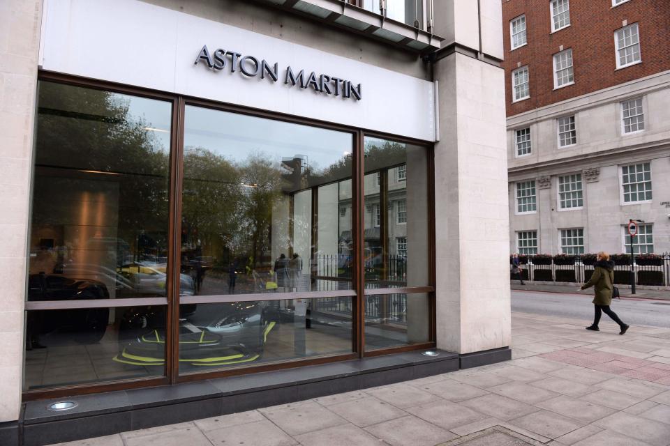 A person walks past the window of Stratstone’s Aston Martin Mayfair dealership on Park Lane, London, whose parent company, Pendragon, has seen its suitor granted an extension over a possible takeover (Stefan Rousseau/PA) (PA Archive)