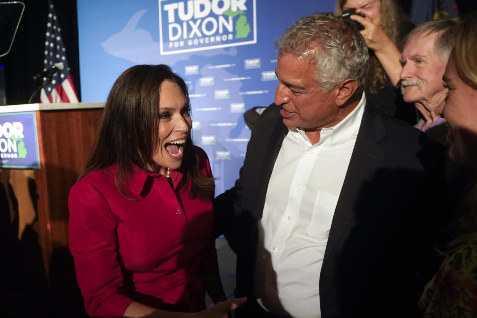 Republican gubernatorial candidate Tudor Dixon, left, greets supporters at a primary election party in Grand Rapids, Mich., Tuesday, Aug. 2, 2022. (AP Photo/Paul Sancya)