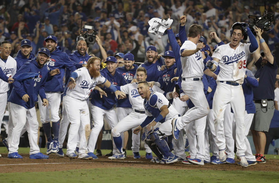 The Los Angeles Dodgers celebrates after Max Muncy’s walk off during the 18th inning in Game 3 of the World Series baseball game against the Boston Red Sox on Saturday, Oct. 27, 2018, in Los Angeles. The Dodgers won 3-2. (AP Photo/Jae C. Hong)