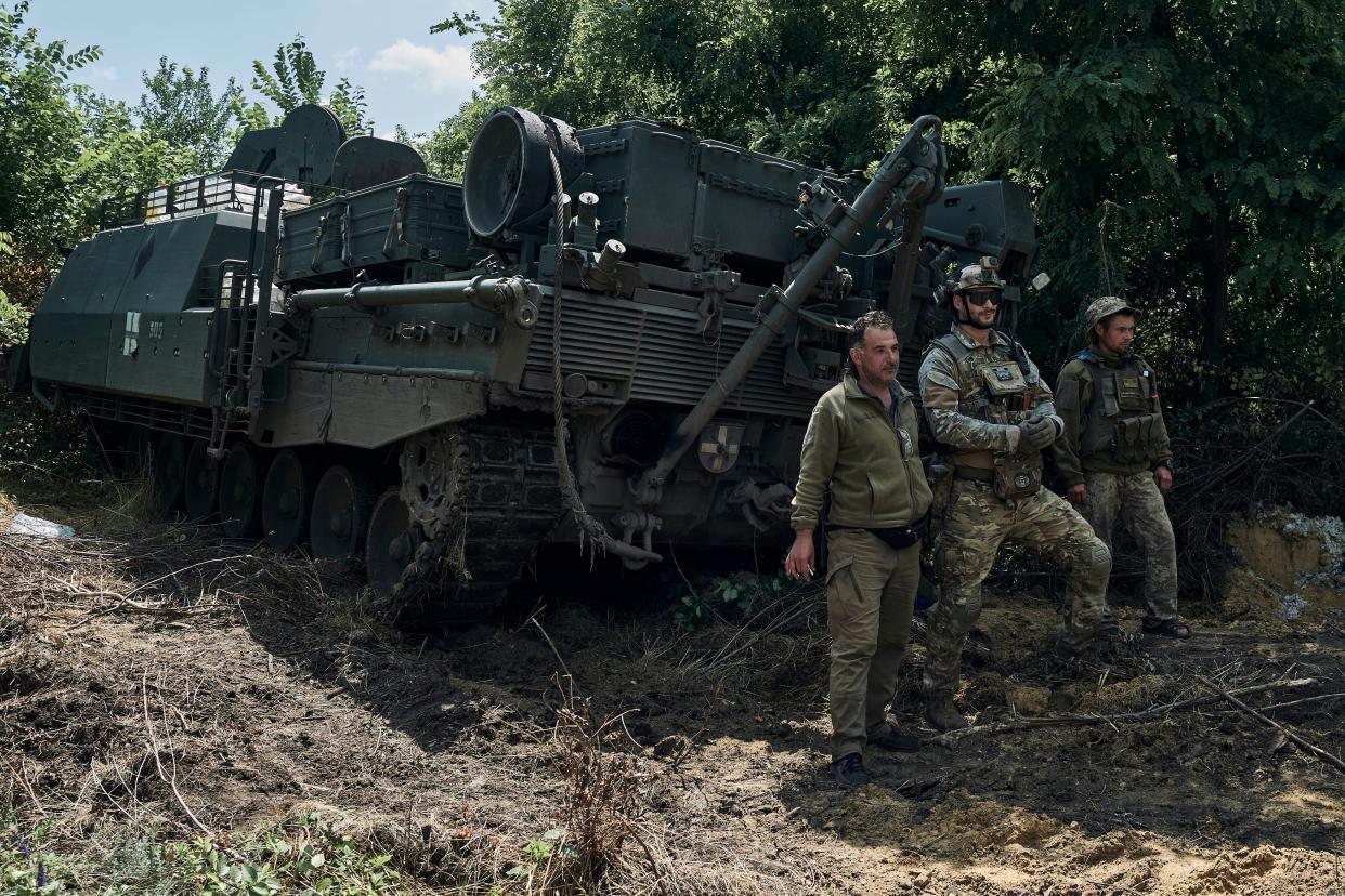 Ukrainian soldiers stands near Bergepanzer 2 armoured recovery vehicle on the frontline in the Zaporizhzhia region (AP)