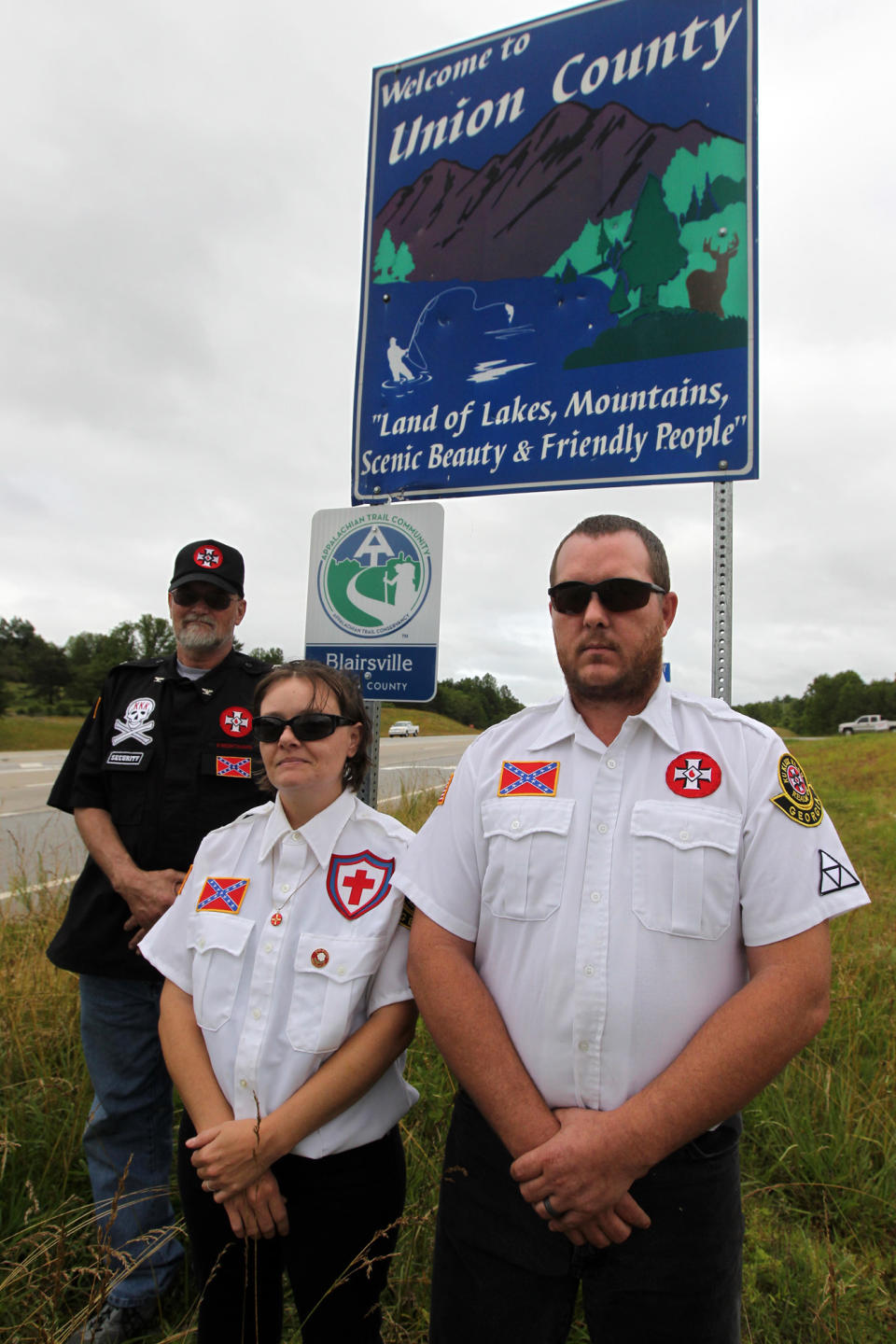 Knighthawk (from left), April Hanson and her husband Harley Hanson, members of the International Keystone Knights Realm of Georgia, perform a traditional Klan stand along the portion of highway they want to adopt allowing them to put up a sign and do litter removal near Blairsville, Ga. on Sunday, June 10, 2012. The Ku Klux Klan group wants to join Georgia's "Adopt-A-Highway" program for litter removal, which could force state officials to make difficult decisions on the application. (AP Photo/The Atlanta Journal-Constitution, Curtis Compton)