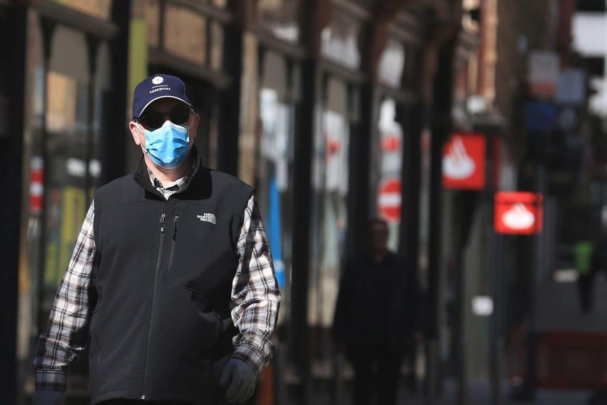 A shopper wears a face mask as he walks in Leeds city centre: AFP via Getty Images