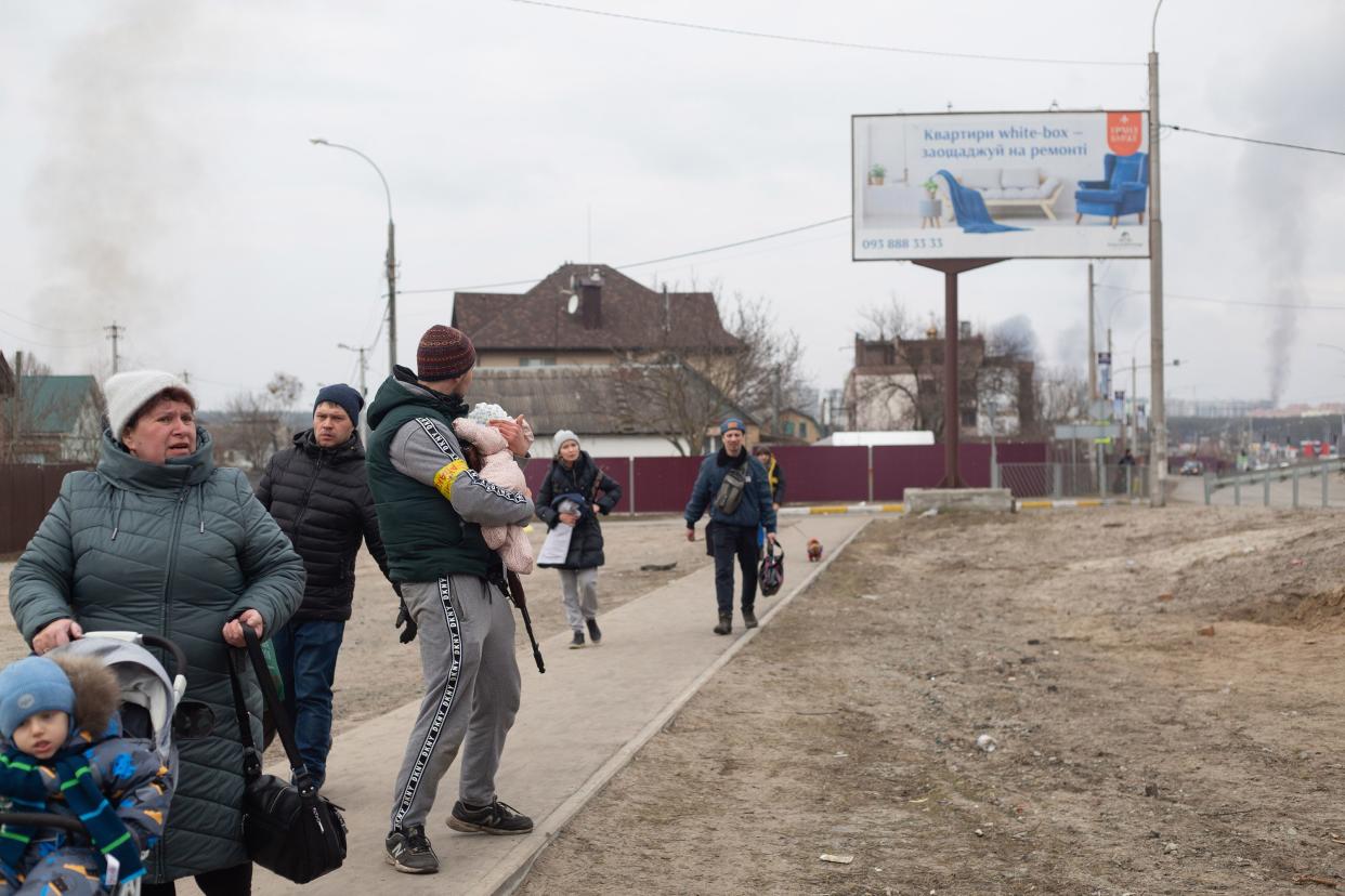 A member of the Territorial Defense Battalion helps to evacuate a child on March 6, 2022, in Irpin, Ukraine. Three civilians were killed and others were wounded as Russian mortar rounds landed between Irpin and Kyiv this morning, striking a route used by civilians fleeing southeast toward Kyiv. Russia continued its assault on Ukraine's major cities, including its capital, more than a week after launching a large-scale invasion of the country.