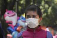 A child wears a medical mask as a precaution against the spread of the new coronavirus, during an outing in Mexico City, Saturday, Feb. 29, 2020. Mexico’s Health Department said late Friday that a new case had been confirmed in Mexico City, adding to the first two confirmed cases announced earlier that day. (AP Photo/Marco Ugarte)