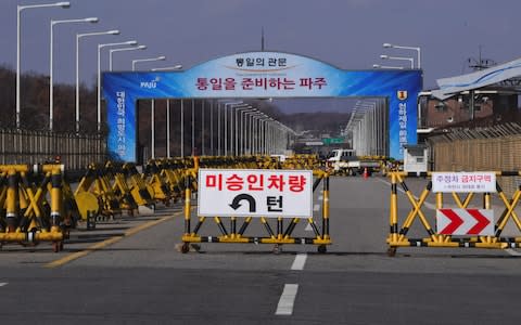 A barricade is set on the road leading to the truce village of Panmunjom at a South Korean military checkpoint in the border city of Paju near the Demilitarized Zone  - Credit: AFP