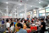 People visit a U.S. hypermarket chain Costco Wholesale Corp store in Shanghai