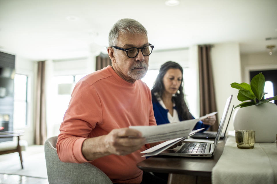 Elderly couple paying bills inside the house