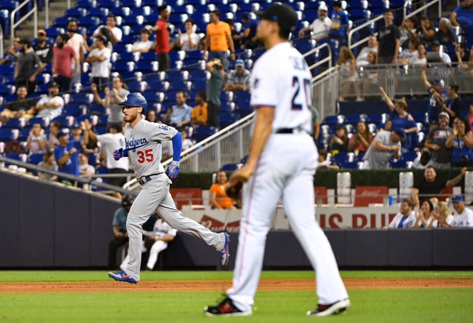 MIAMI, FL - AUGUST 13: Cody Bellinger #35 of the Los Angeles Dodgers runs the bases after hitting his 39th homerun of the season as Wei-Yin Chen #20 of the Miami Marlins looks on in the seventh inning at Marlins Park on August 13, 2019 in Miami, Florida. (Photo by Mark Brown/Getty Images)