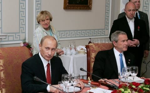 Mr Putin meets with George W. Bush and other world leaders at a 2006 dinner served by Mr Prigozhin, who is seen at right - Credit: Sergei Zhukov/Sputnik, Kremlin Pool Photo via AP, file