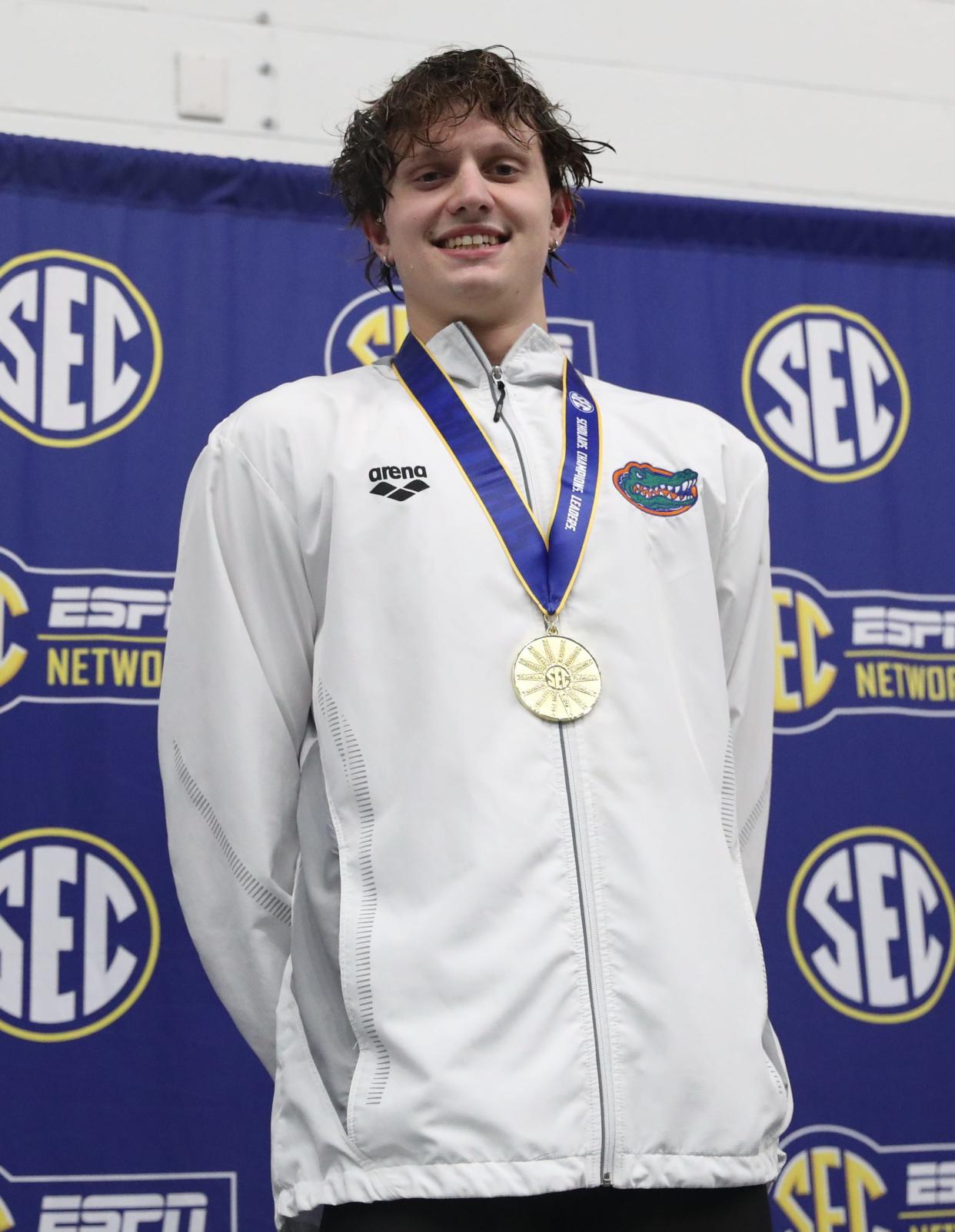 University of Florida freshman Jonny Marshall smiles atop the podium in the SEC Championship meet on Friday, February 23, 2024 at James E. Martin Aquatic Center in Auburn, Ala.