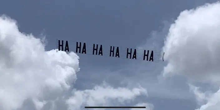 Trump critics flew a banner that read &quot;HA HA HA HA HA HA&quot; above protestors at his Mar-a-Lago residence after his house was raided by the FBI.