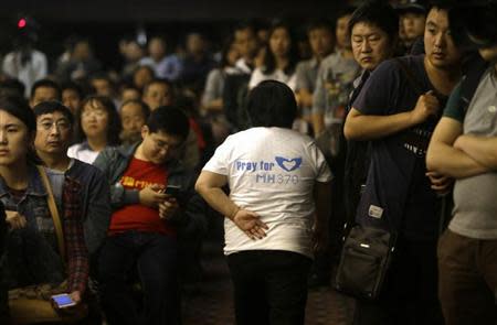 A relative of a passenger aboard Malaysia Airlines flight MH370 leaves a briefing given by Malaysian representatives at Lido Hotel in Beijing April 21, 2014. REUTERS/Jason Lee