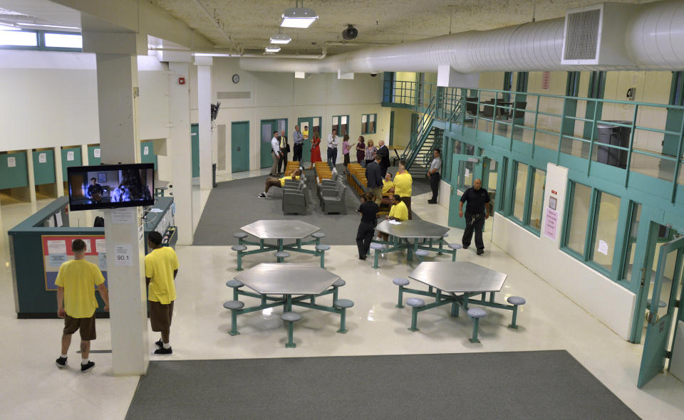 In this July 9, 2019 photo, clients gather in an open area at the Stonybrook Stabilization and Treatment Center at the Hampden County Correctional Center in Ludlow, Mass. Sheriff Thomas Cocchi and his supporters have said the program, one of just three in the state treating civilly committed men and the only in western Massachusetts, can play a key role in efforts to curb the Springfield area's opioid problem. But civil rights group want the practice of imprisoning men for addiction treatment ended. (Don Treeger/The Republican via AP, File)