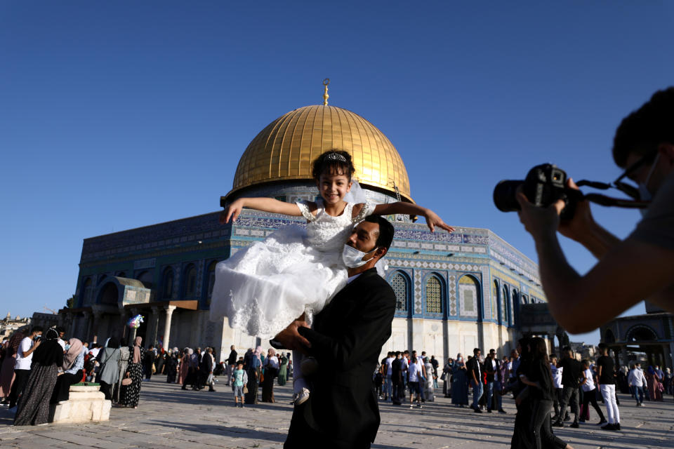 A girl poses for a photo during celebrations for the Muslim holiday of Eid al-Adha on the compound known to Muslims as Noble Sanctuary and to Jews as Temple Mount in Jerusalem's Old City amid the coronavirus disease (COVID-19) outbreak in Jerusalem July 31, 2020. REUTERS/Ammar Awad