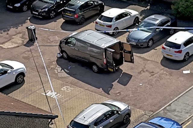<p>Jordan Pettitt/PA Images via Getty</p> An open-doored van is cordoned off Tuesday, April 30, following a sword-attack in East London.