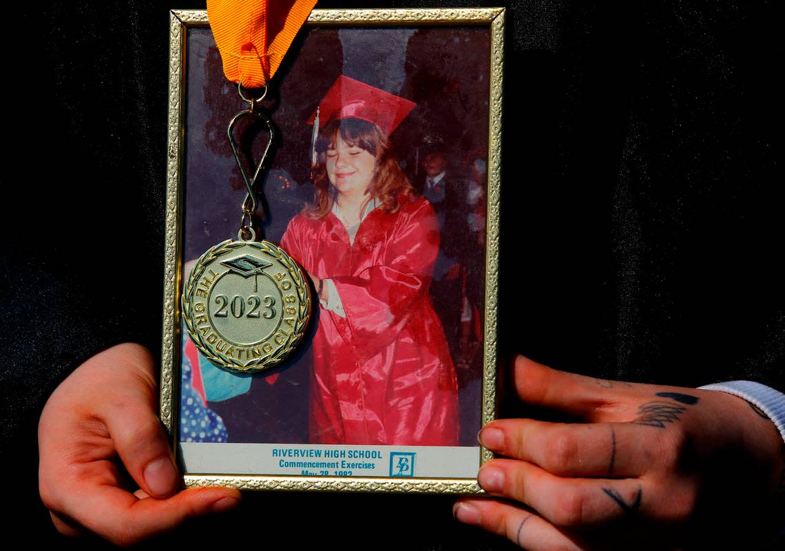 Shannon Nourse, 19, holds a River View High School graduation photo from showing her mother, Chantal Harrison, at the 1982 commencement ceremony. She has overcome the death of her mother last year and other struggles to be one of about 40 graduates from the online Endeavor High School in 2023.