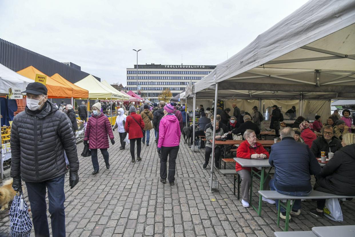 People wear face masks at the Hakaniemi Sunday market in Helsinki, Finland, on November 1, 2020, amid the novel coronavirus COVID-19 pandemic. - Finland has now 16 291 confirmed cases of Covid-19 with 358 fatalities. (Photo by Markku Ulander / Lehtikuva / AFP) / Finland OUT (Photo by MARKKU ULANDER/Lehtikuva/AFP via Getty Images)