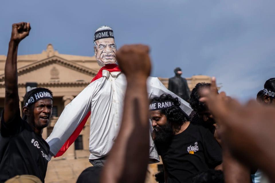 Protesters shout slogans demanding acting president and prime minister Ranil Wickremesinghe resign in Colombo, Sri Lanka, in Colombo a day before the vote (AP)