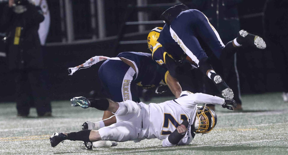 Moeller defensive back Tyler Mccoy (21) tackles a Springfield receiver during their playoff game, Friday, Nov. 26, 2021.