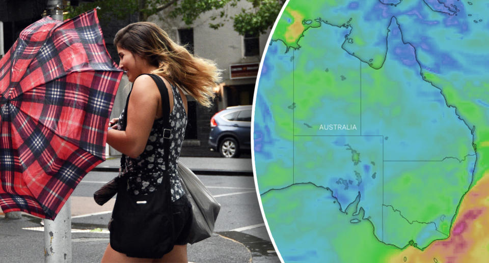 A woman's red umbrella is blown to the side in Melbourne.