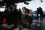Stranded American citizens arrive to board a Qatar Airways flight at the Tribhuvan International Airport in Kathmandu, Nepal, Tuesday, March 31, 2020. Several American citizens are stranded in Nepal due to the nationwide lockdown enforced in an attempt to stop the coronavirus spread. The new coronavirus causes mild or moderate symptoms for most people, but for some, especially older adults and people with existing health problems, it can cause more severe illness or death. (AP Photo/Niranjan Shrestha)