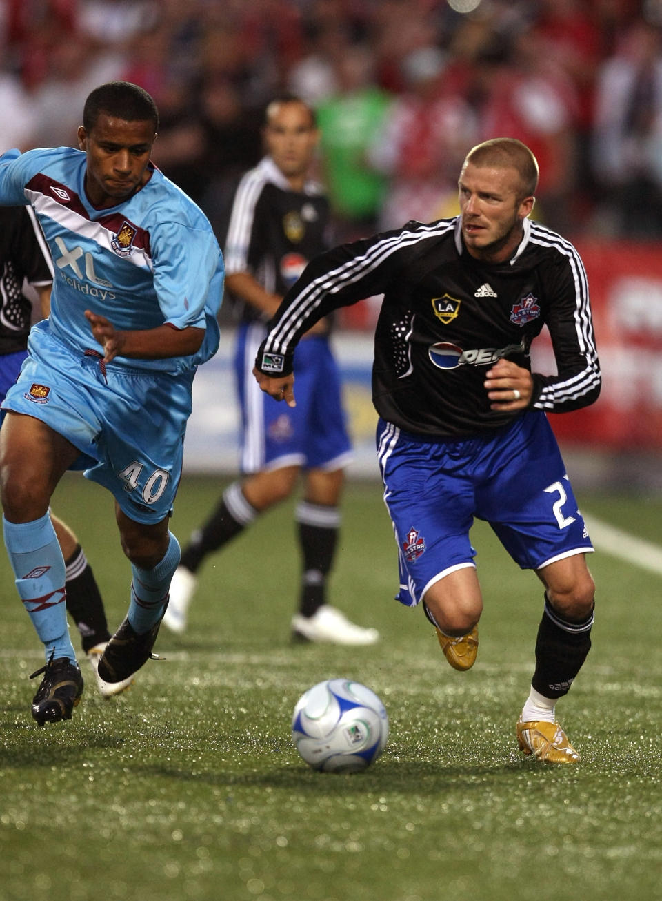 TORONTO - JULY 24: Midfielder #23 David Beckham of L.A. Galaxy brings the ball up field against defender #40 Freddie Sears of West Ham United during the 2008 Pepsi MLS All Star Game between the MLS All Stars and West Ham United at BMO Field on July 24, 2008 in Toronto, Canada. (Photo by Jonathan Daniel/Getty Images)