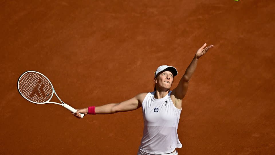 Świątek serves against Karolína Muchová during last year's final at Roland Garros. - Julien de Rosa/AFP/Getty Images