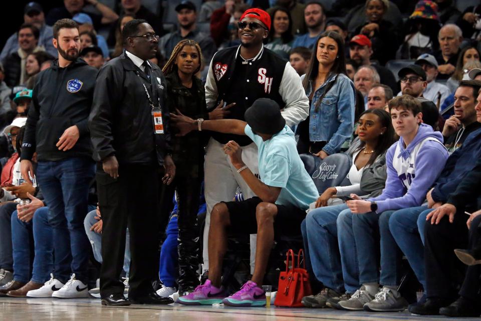 Jan 29, 2023; Memphis, Tennessee, USA; Davonte Pack, friend of Memphis Grizzlies player Ja Morant, is held back by Tee Morant, father of Ja after a verbal altercation with Indiana Pacers players during the second half at FedExForum. Pack was escorted off the court side by security. Mandatory Credit: Petre Thomas-USA TODAY Sports