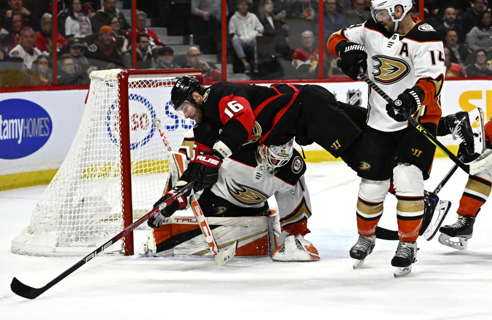 Ottawa Senators left wing Austin Watson (16) falls in front of Anaheim Ducks goaltender Lukas Dostal (1) who makes a save during second-period NHL hockey game action in Ottawa, Ontario, Monday, Dec. 12, 2022. (Justin Tang/The Canadian Press via AP)