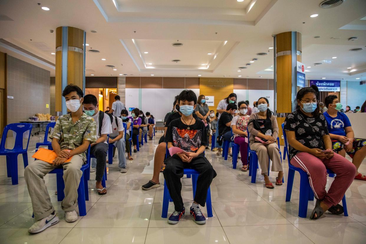 Thai teenagers wait in line to receive their first dose of Pfizer's COVID-19 vaccine at Vachira Hospital on Sept. 21, 2021, in Bangkok, Thailand.