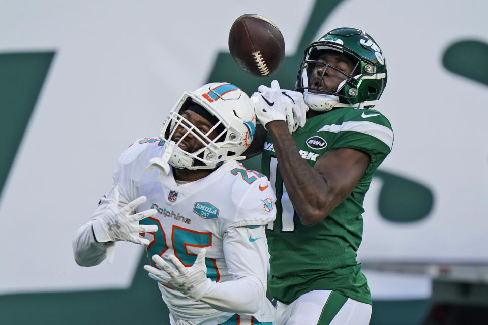 New York Jets' Denzel Mims, right, cannot hold onto the ball in the end zone while Miami Dolphins' Xavien Howard defends during the second half of an NFL football game, Sunday, Nov. 29, 2020, in East Rutherford, N.J. (AP Photo/Corey Sipkin)