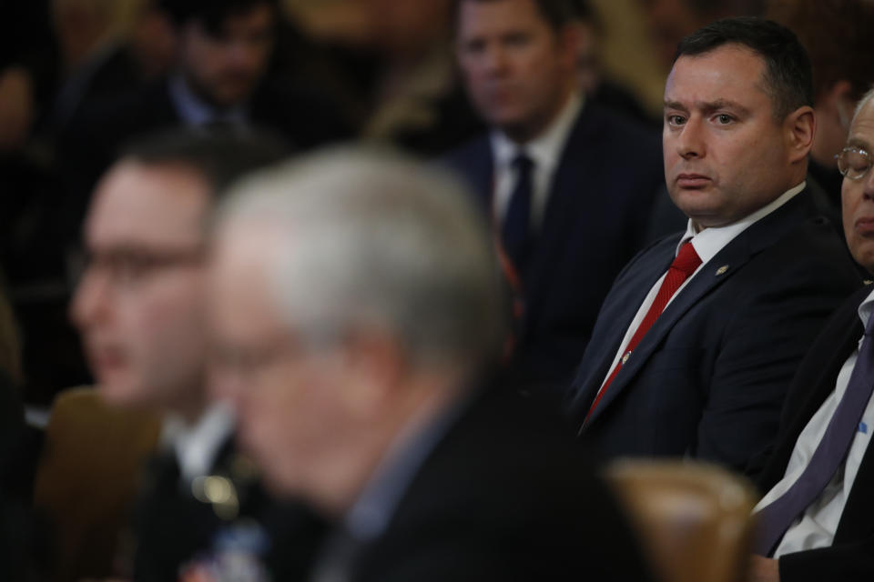 FILE - In this Nov. 19, 2019, file photo Army Lt. Col. Yevgeny Vindman, sits behind his twin brother National Security Council aide Lt. Col. Alexander Vindman, as he testifies before the House Intelligence Committee on Capitol Hill in Washington during a public impeachment hearing of President Donald Trump's efforts to tie U.S. aid for Ukraine to investigations of his political opponents. House Democrats are asking a Pentagon watchdog for an investigation into what they say was a “concerted effort” by the Trump administration to retaliate against a key impeachment witness, Lt. Col. Alexander Vindman, and his twin brother. (AP Photo/Alex Brandon, File)