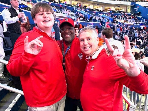 Billy West, right, Cumberland County's district attorney, and his son, Will, and Dereck Whittenburg, center, one of the stars of N.C. State University's 1983 men's basketball championship, are shown at 2024 ACC Tournament.