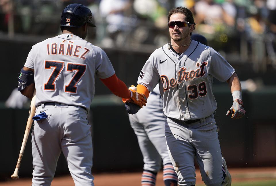 Zach McKinstry of the Detroit Tigers is congratulated by Andy Ibanez after McKinstry scored against the Oakland Athletics in the top of the third inning at RingCentral Coliseum on September 23, 2023 in Oakland, California.