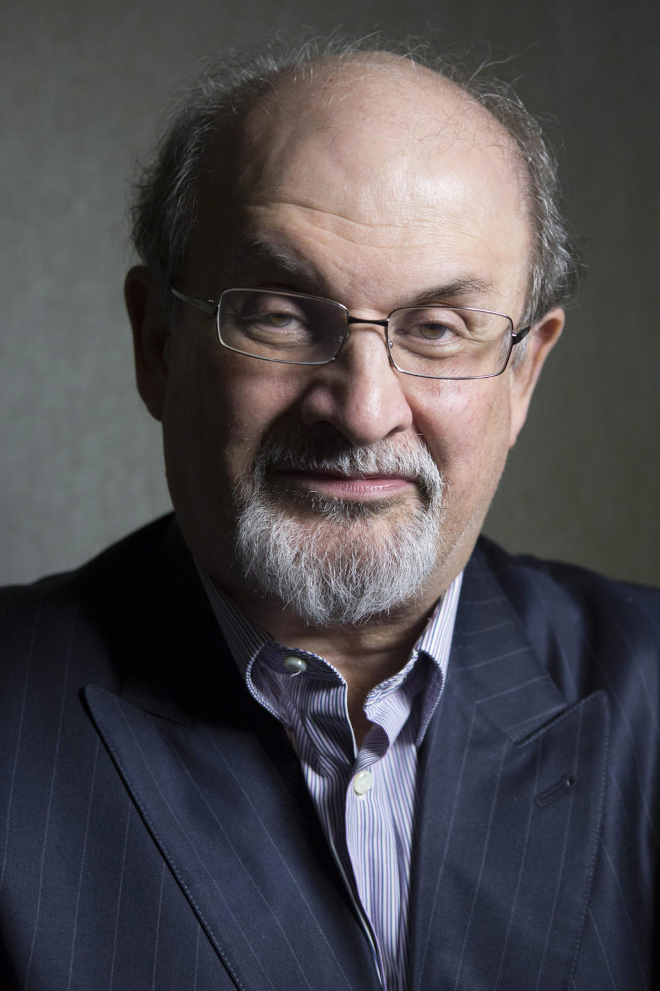 FILE - This Sept. 8, 2012 file photo shows author Salman Rushdie posing during the 2012 Toronto International Film Festival in Toronto. Rushdie is promoting the film adaptation of his breakthrough novel, "Midnight's Children," winner of the Booker Prize in 1981 and one of the most highly praised works of fiction of its time. (AP Photo/The Canadian Presss, Chris Young, file)