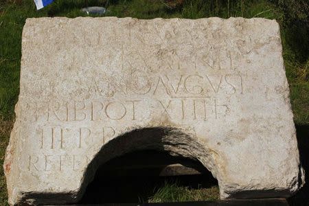 A stone bearing an ancient Latin inscription is displayed for the media outside Rockefeller Archaeological Museum in Jerusalem October 21, 2014. REUTERS/Ronen Zvulun