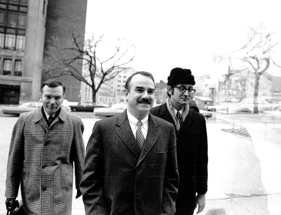 <p>Three of the seven defendents — including G. Gordon Liddy, center — charged in connection with the break-in and alleged bugging of Democratic headquarters arrive at U.S. District Court for the start of their trial on Jan. 8, 1973. The other men are unidentified. (Photo: AP) </p>