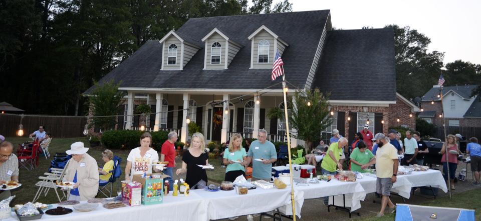 Dozens of residents from the Bradford Place subdivision enjoy food, fellowship and music during Night Out festivities held in Madison on Tuesday, Oct. 3.