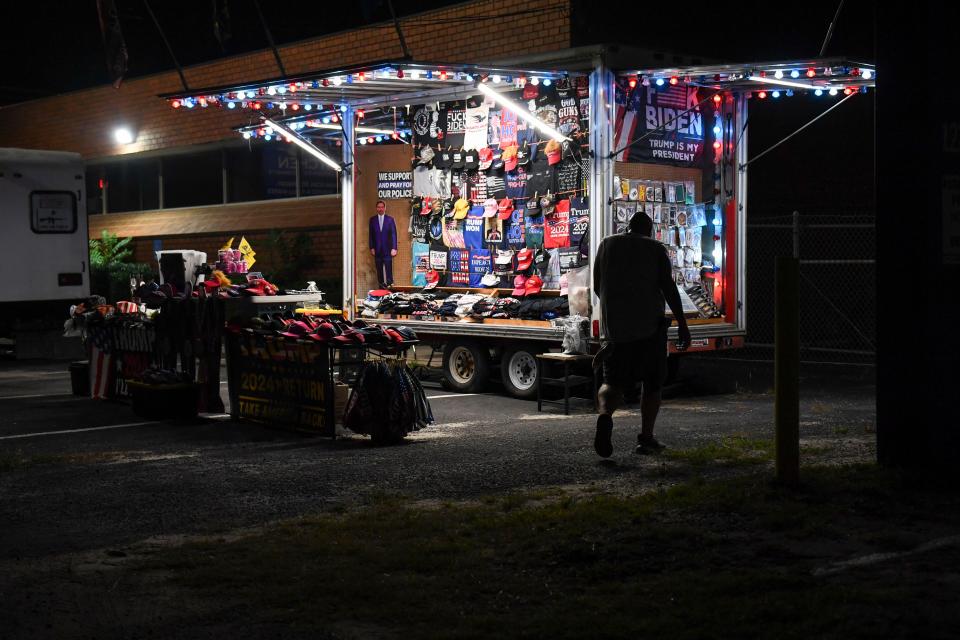 Joe Prince, 48, sells Trump merchandise from his mobile shop near the South Carolina State Fairgrounds after the 56th annual Silver Elephant Gala, where Trump was the keynote speaker, in Columbia, S.C., on Saturday, Aug. 5, 2023.