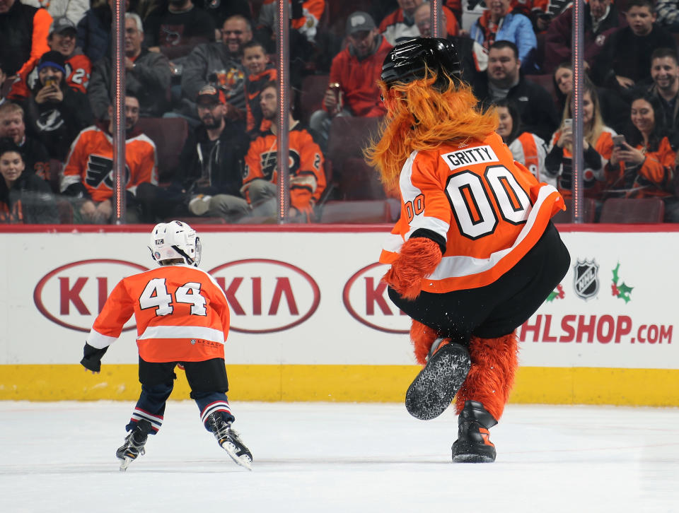 PHILADELPHIA, PA - NOVEMBER 17:  Gritty, the mascot of the Philadelphia Flyers interacts with a member of the mites on ice during the second period intermission against the Tampa Bay Lightning on November 17, 2018 at the Wells Fargo Center in Philadelphia, Pennsylvania.  (Photo by Len Redkoles/NHLI via Getty Images)