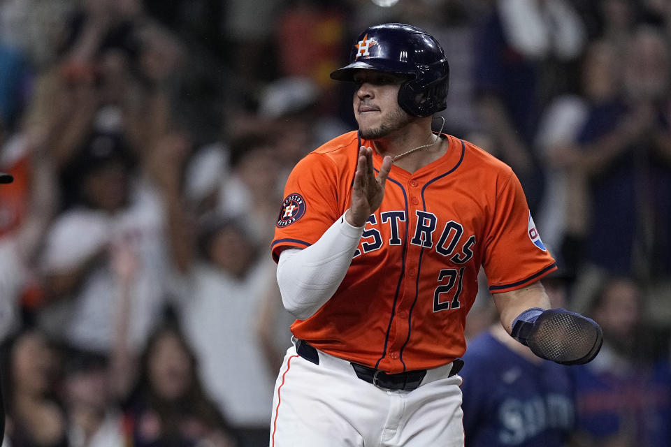 Houston Astros' Yainer Diaz celebrates after scoring on a sacrifice fly by Mauricio Dubón during the seventh inning of a baseball game against the Seattle Mariners Friday, May 3, 2024, in Houston. (AP Photo/Kevin M. Cox)