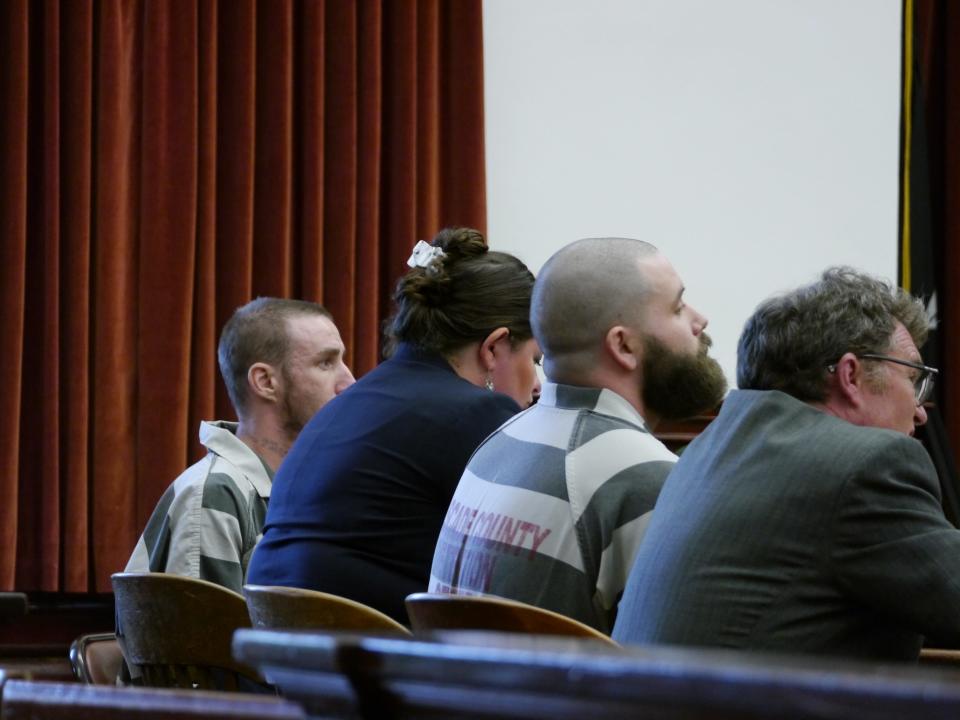 From left, Troy Allan Nelson, attorney Claire Lettow, Ryan Patrick Morris and attorney Mark Frisbie listen as Judge Greg Pinski addresses the concept of stolen valor Friday in Cascade County, Mont.