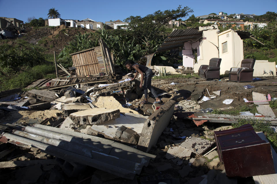 FILE - Alwande Ndlovu, stands where a neighbor's house once stood, after heavy rains caused flood damage in Umgababa, near Durban, South Africa, April 19, 2022. Rich countries say they will spend about $25 billion by 2025 to boost Africa’s efforts to adapt to climate change as the continent continues to struggle with drought, cyclones and extreme heat, according to officials at a summit in Rotterdam in the Netherlands. (AP Photo, File)